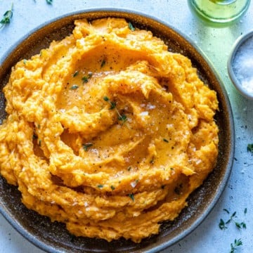 mashed sweet potato in a brown rustic bowl