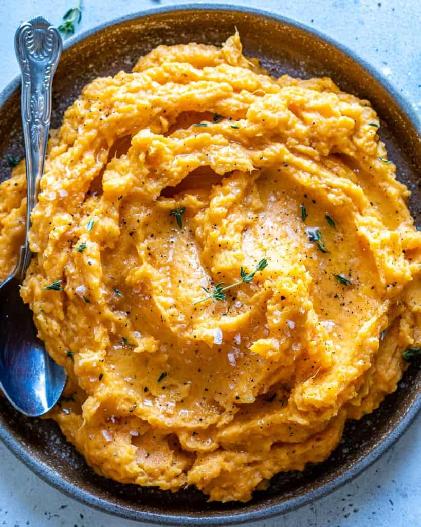 top view mashed sweet potatoes with spoon in it 