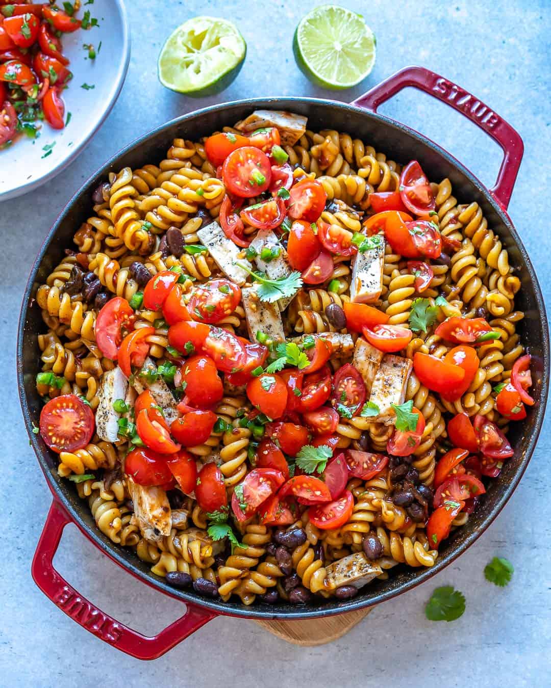 Mexican Chipotle Chicken Pasta in large pan with limes on counter