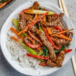 top view of Mongolian beef with rice in a white bowl