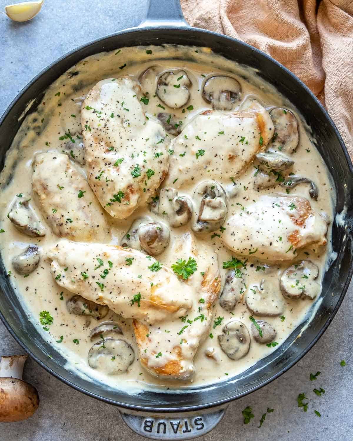 a skillet with creamy chicken and mushroom.