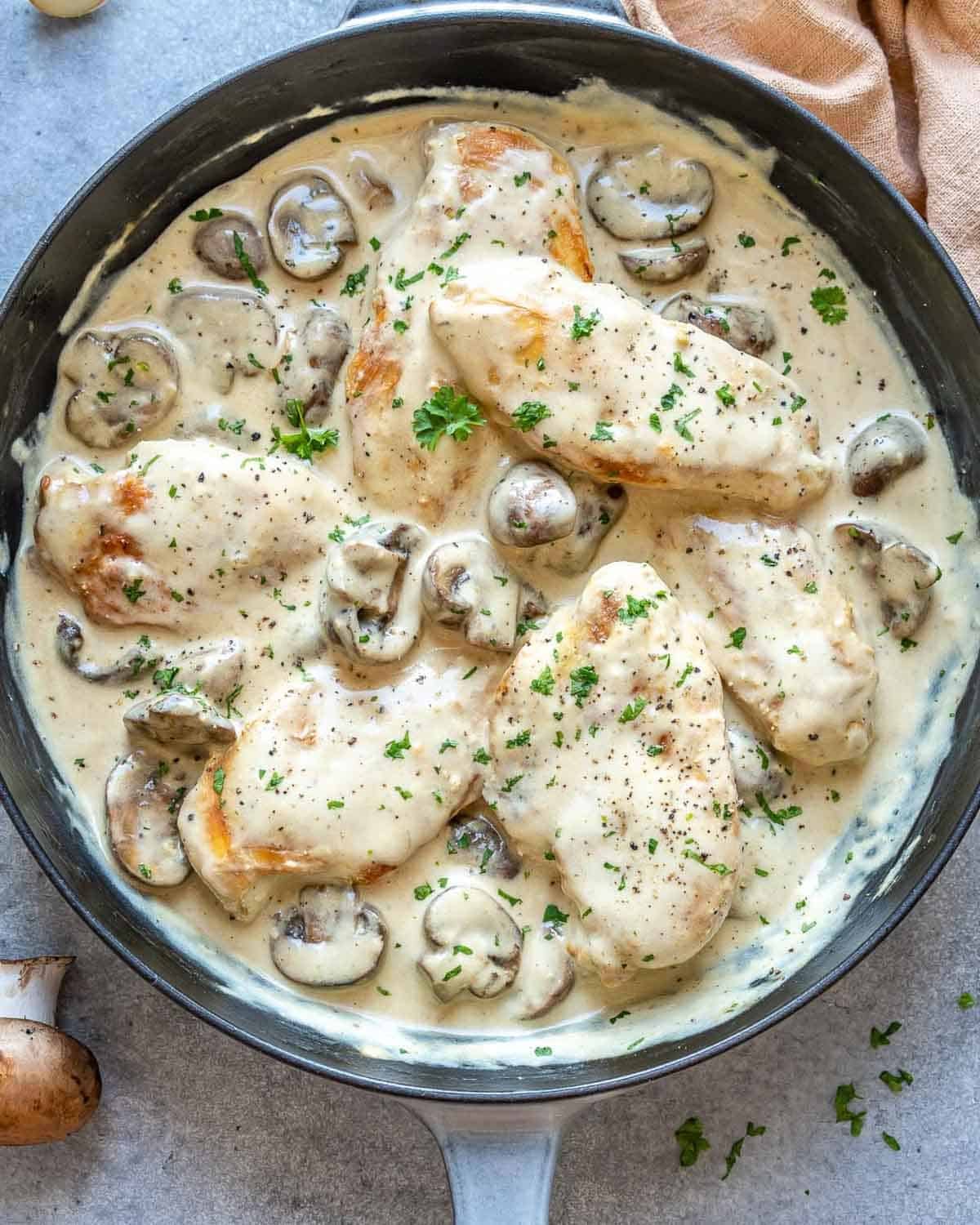 a skillet with creamy chicken and mushroom sauce.