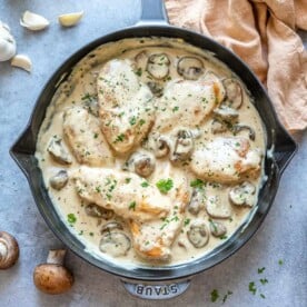 top view of mushroom chicken in a blue skillet