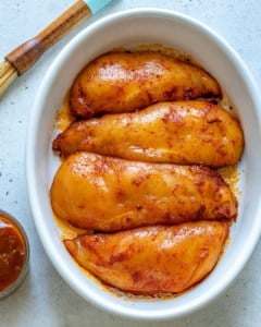 Raw chicken in baking dish before adding BBQ sauce