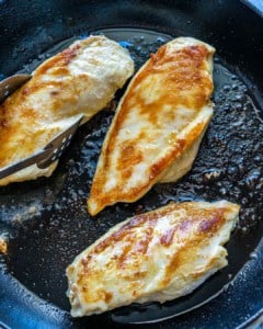 cooked chicken in skillet for chicken pasta salad.