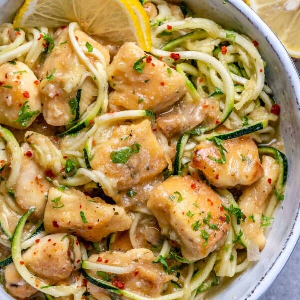 top view of chicken scampi with zoodles in white bowl