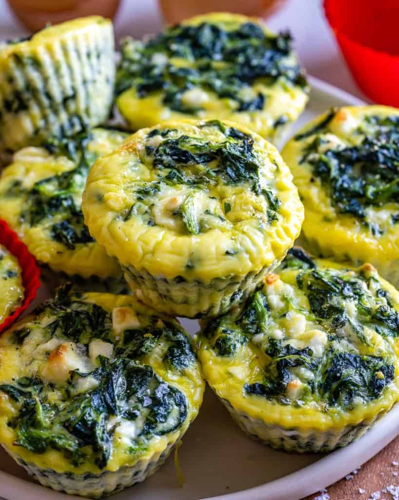 Spinach and Feta Baked Egg Muffins stacked on white plate