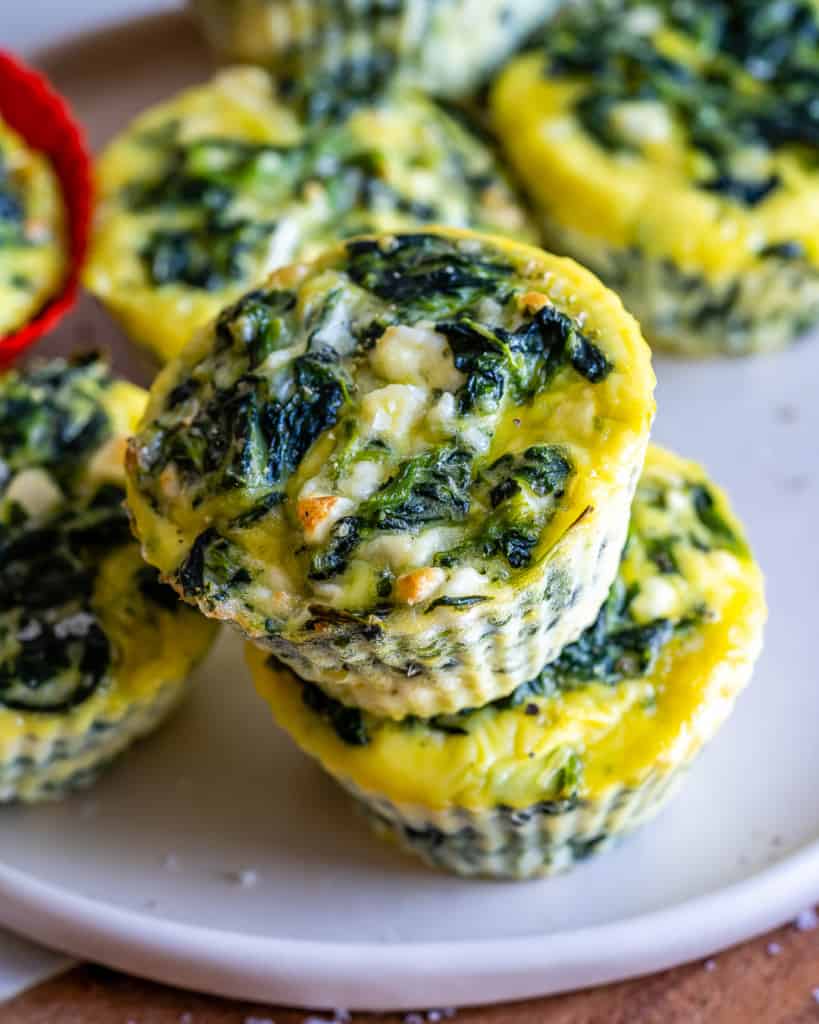 Top view of breakfast egg cups with spinach and feta