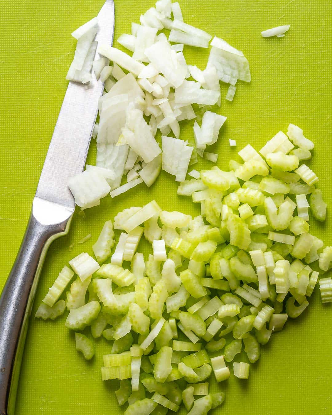 chopping celery with knife on cutting boardMex