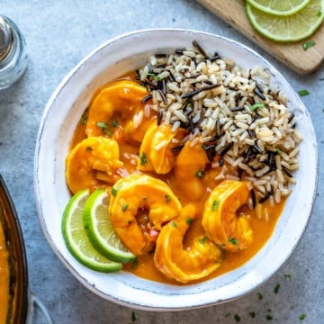 top view of shrimp curry with wild rice in a white bowl