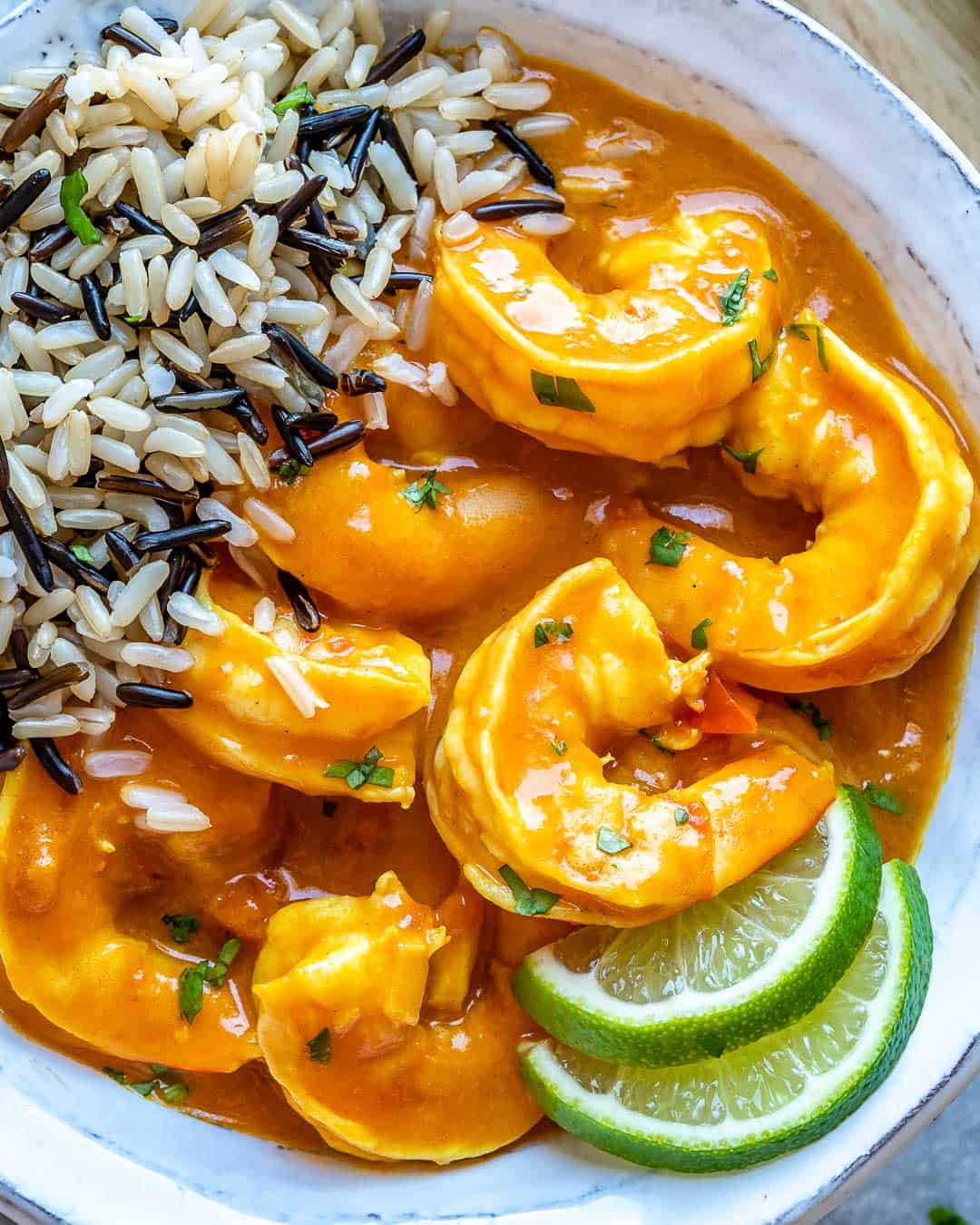 Close view of shrimp in bowl of shrimp curry with rice