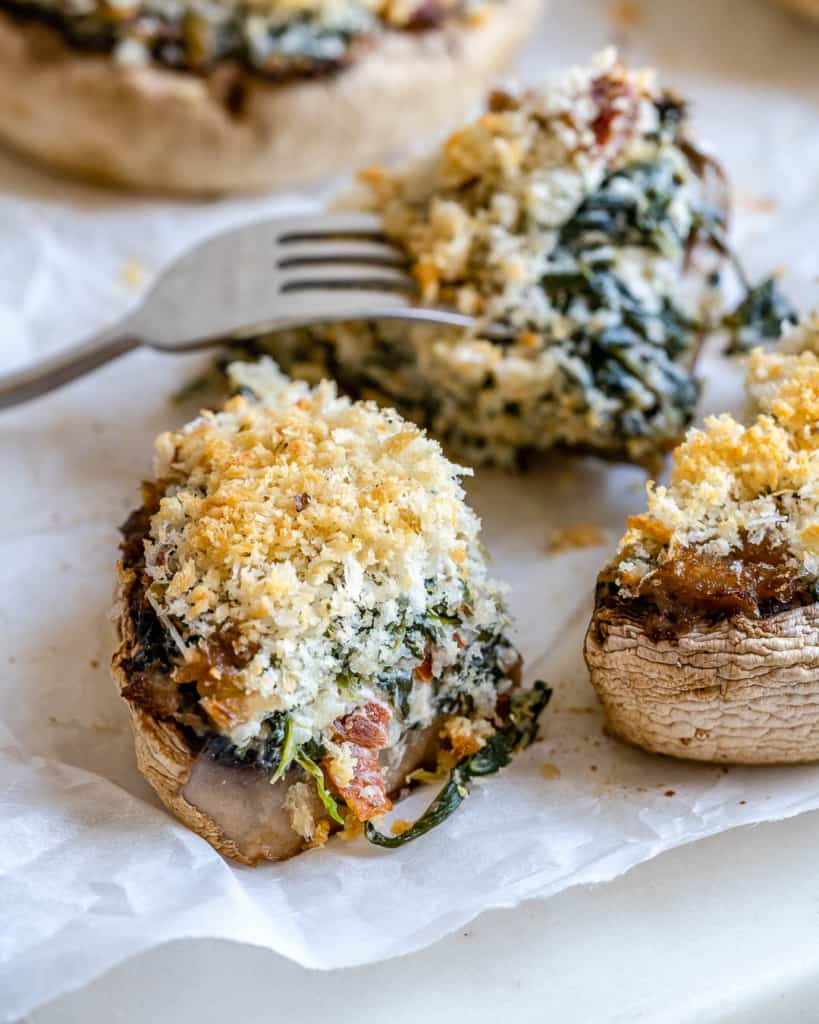 close up and cut up stuffed mushroom with fork