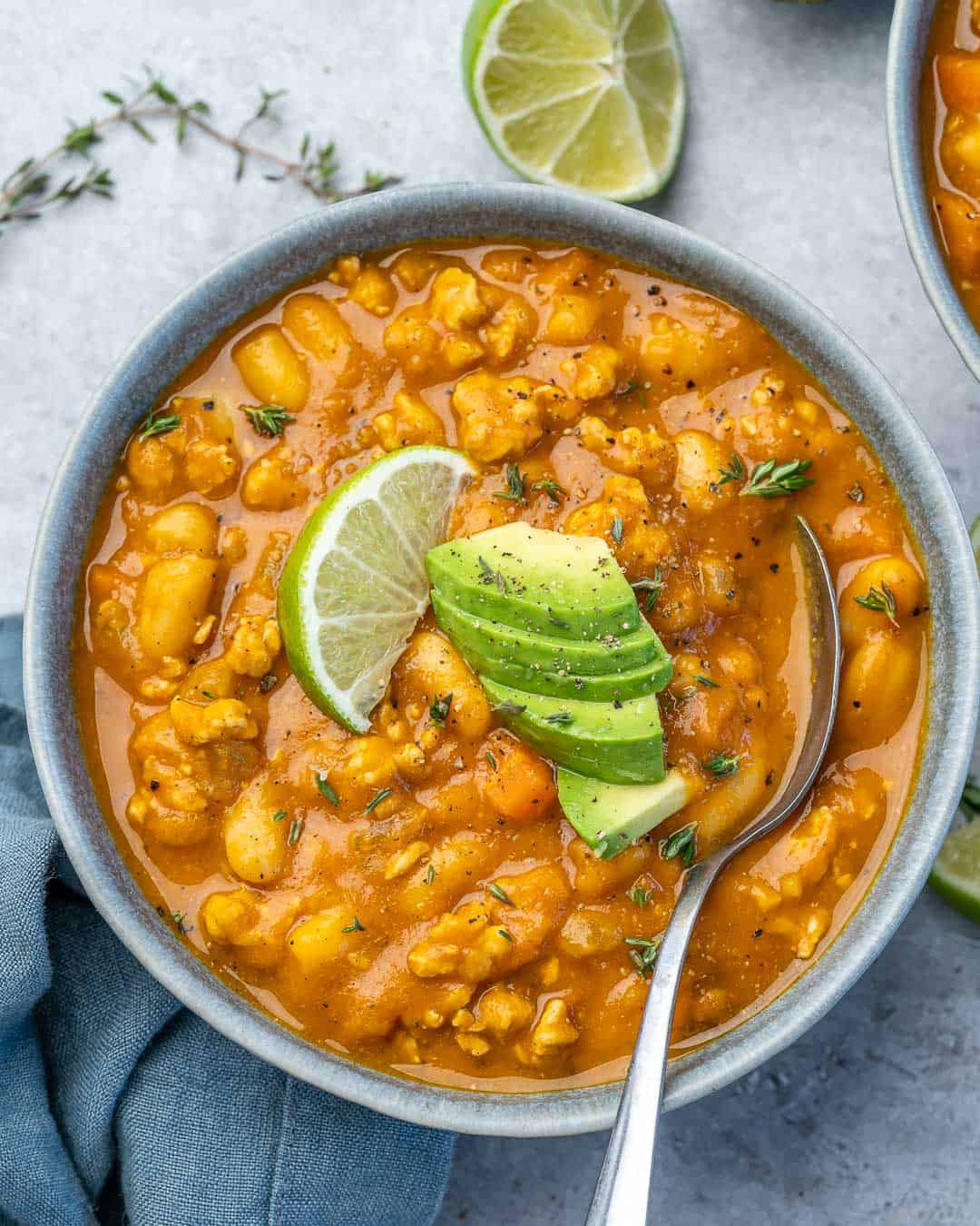 top view of a bowl pumpkin chili with spoon in it