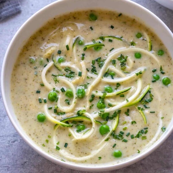 zucchini noodle and broccoli soup in a white bowl.