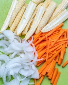 Onion, baby corn, and carrots sliced.