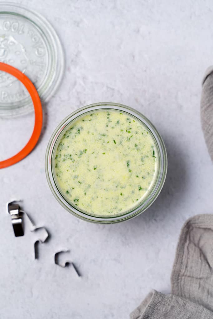 Creamy cilantro dressing in a small glass jar.