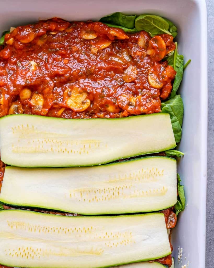 Partial layers of zucchini and marinara for Vegan Lasagna