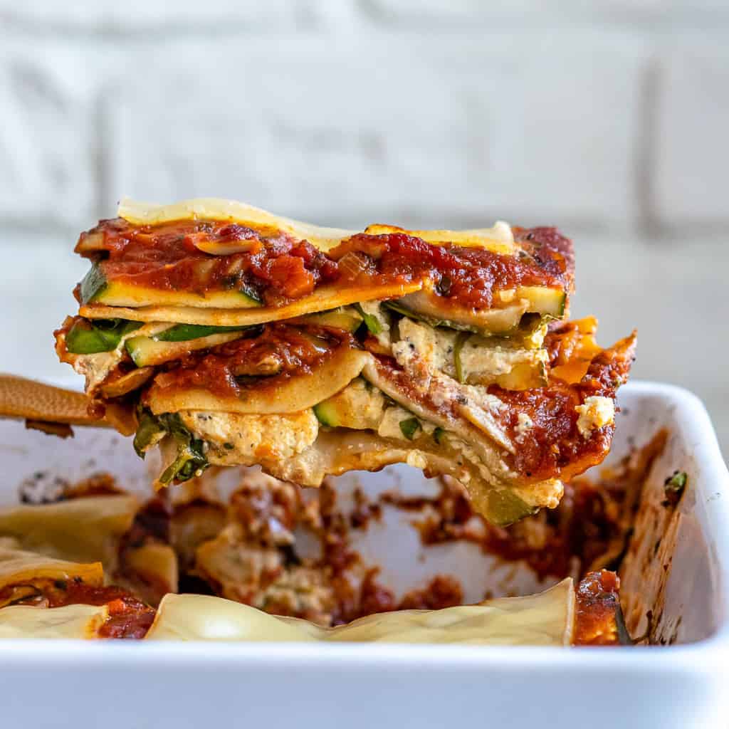 Spatula lifting slice of vegan lasagna out of pan