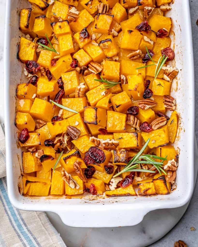 top view roasted butternut squash in a white baking dish 