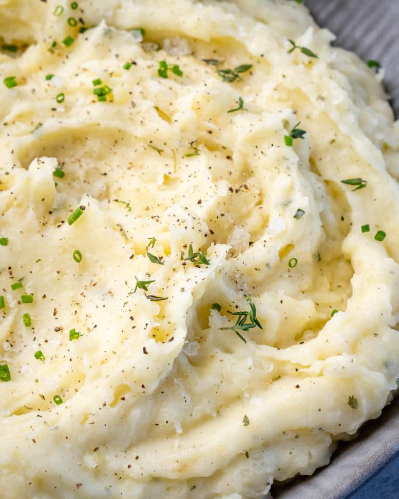 Creamy potato mash in a grey bowl.
