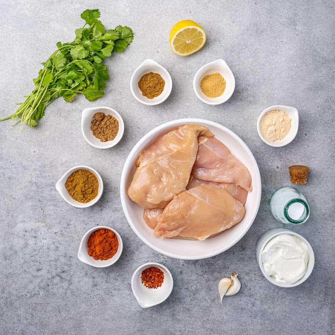 Ingredients for tandoori chicken on gray counter