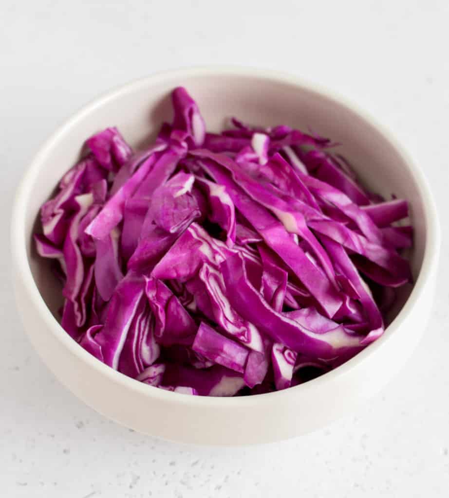 shredded red cabbage in white bowl