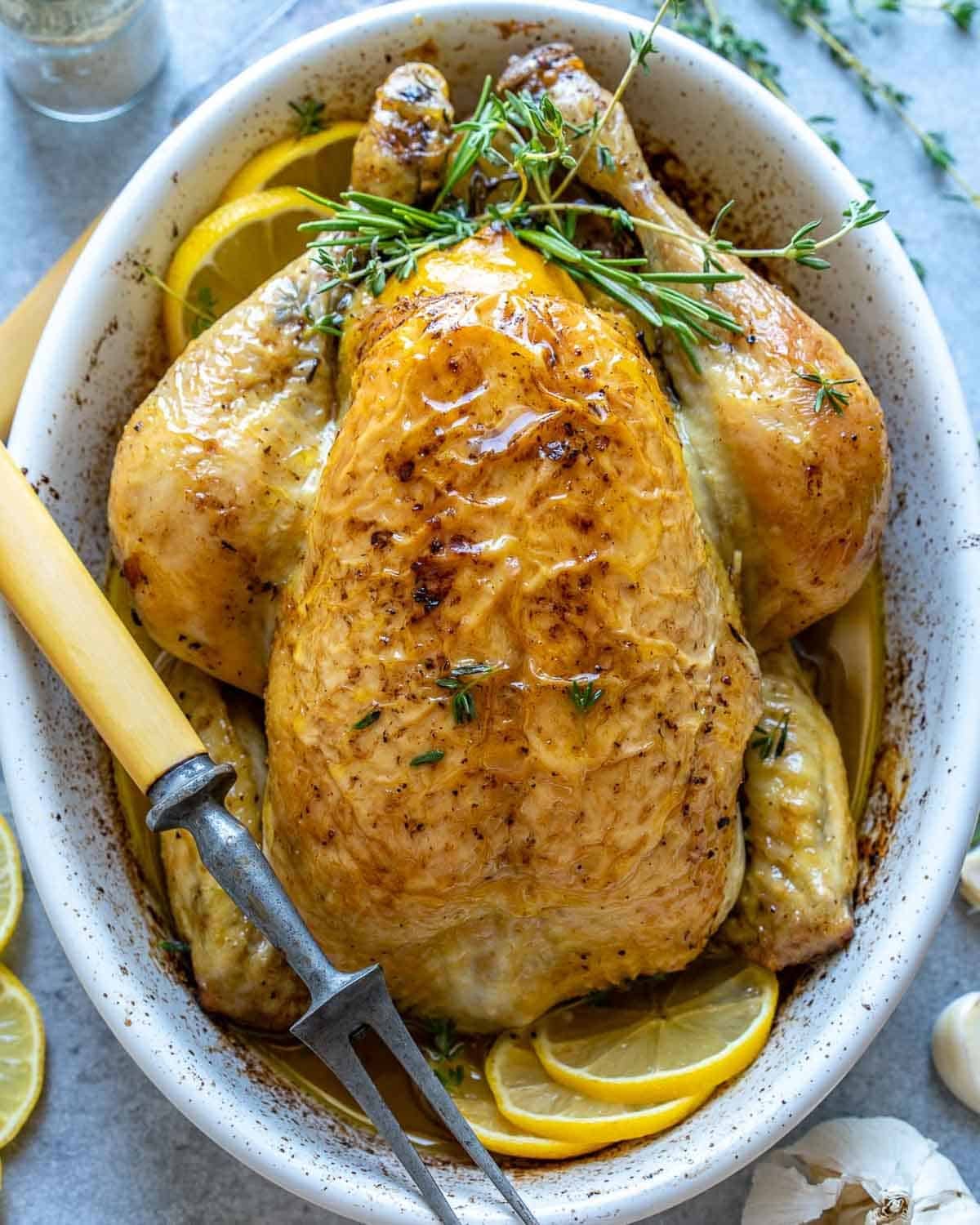 roasted whole chicken in a baking dish.