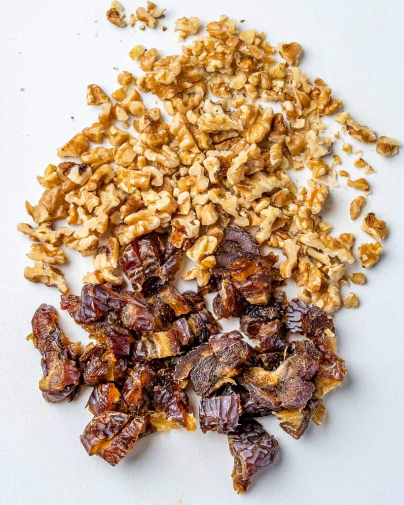 chopped walnuts and dates on a cutting board