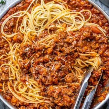 tongs in a pasta bolognese pan