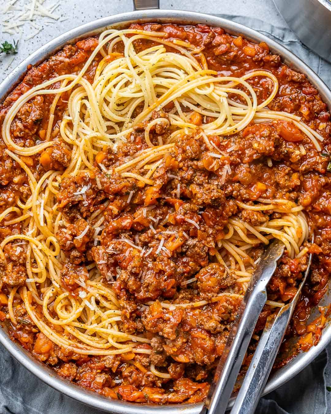 tongs in a pasta bolognese pan