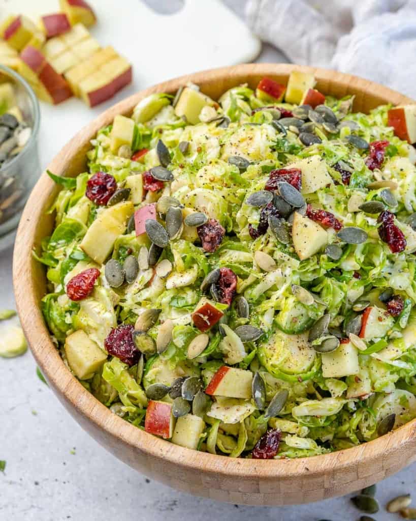 A brown bowl of Brussel sprouts salad.