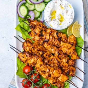 top view chicken shish tawook skewers on a long white dish