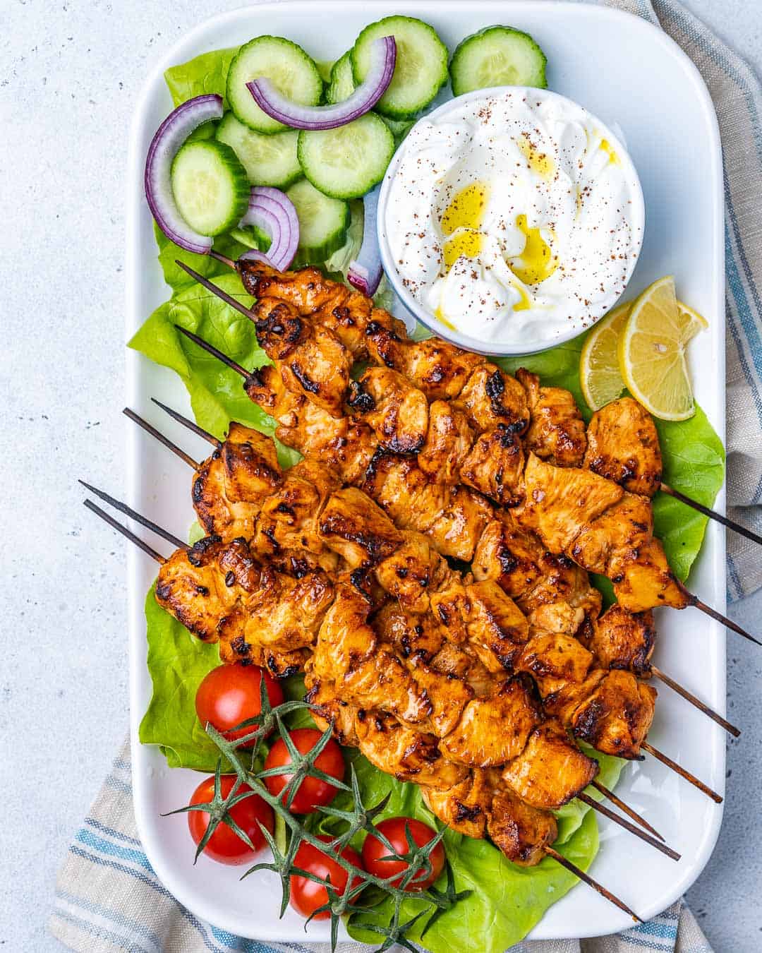 top view chicken shish tawook skewers on a long white dish