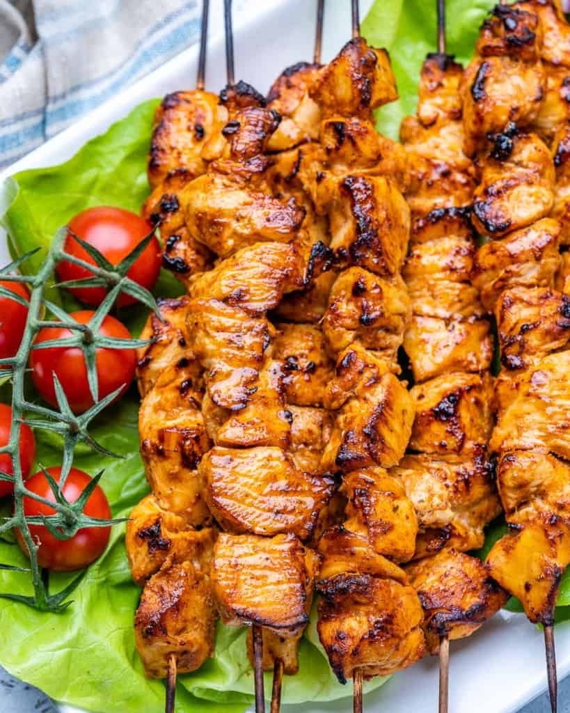 close up grilled shish tawook skewers on plate