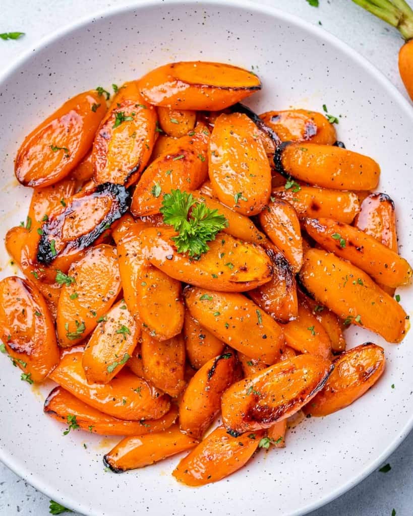 top view roasted carrots on a white plate 