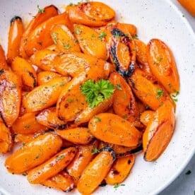top view of glazed carrots in a white plate
