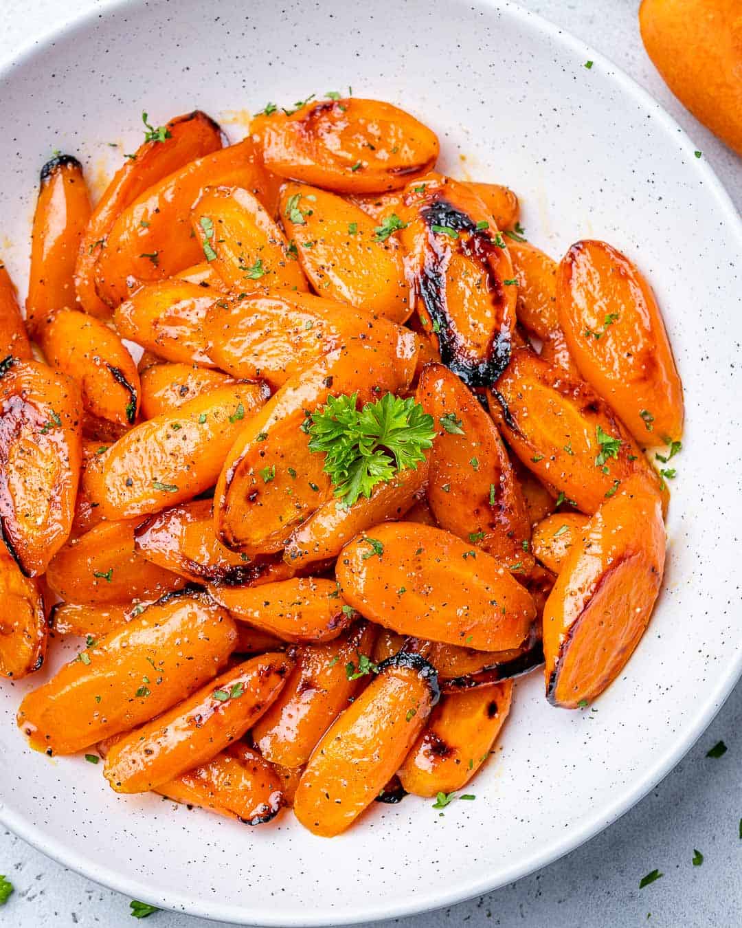 top view of glazed carrots in a white plate