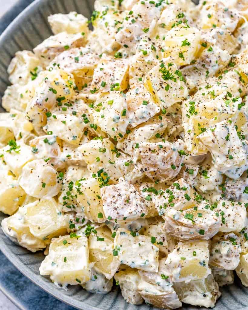 close up potato salad garnished with chives