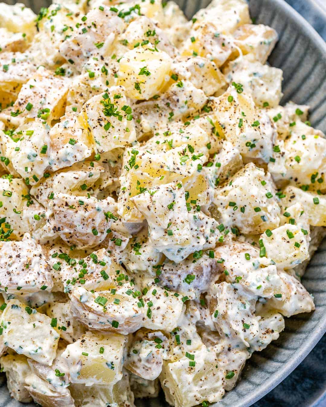 Close view of finished Healthy Mustard potato Salad in gray bowl
