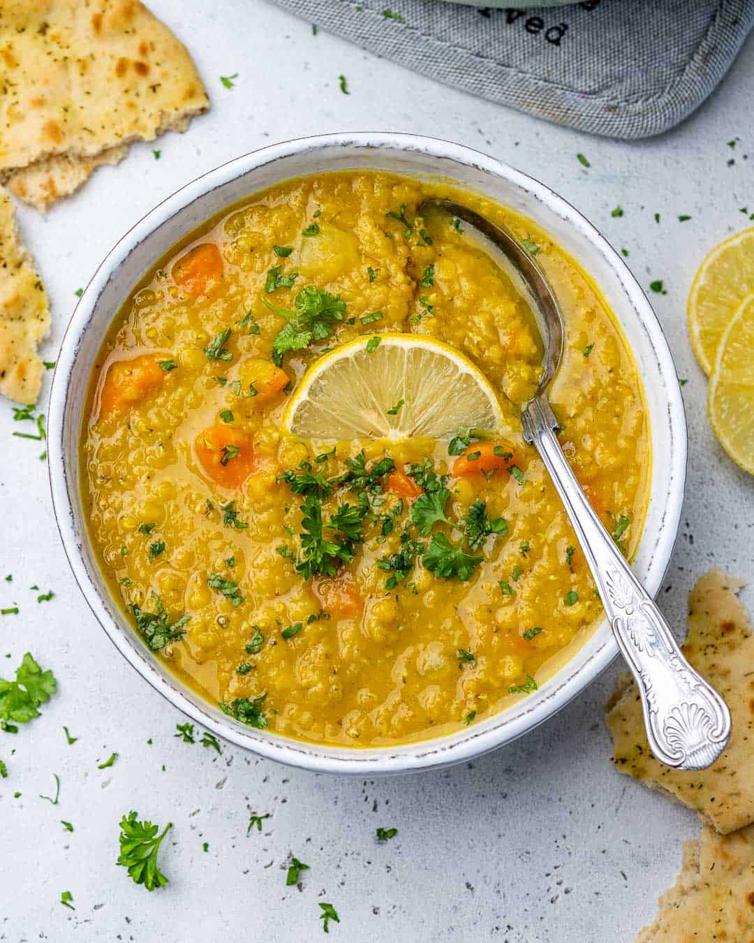 Top view of Middle Eastern Red Lentil Soup garnished with lemon and parsley