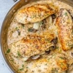top view of 4 stuffed chicken breast in a gray skillet