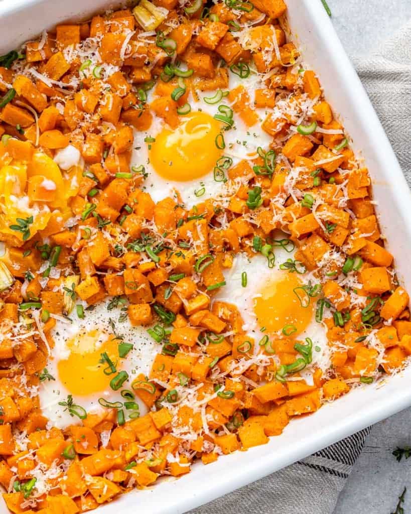 close up sweet potato hash with baked eggs 