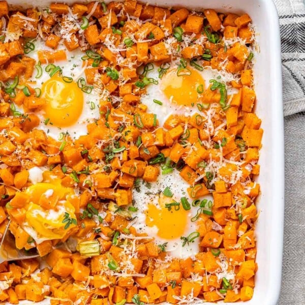 sweet potato hash and eggs in a white baking dish