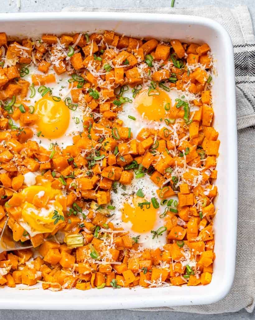 sweet potato hash and eggs in a white baking dish