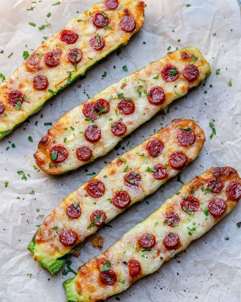 Four zucchini pizza boats topped with pepperoni.
