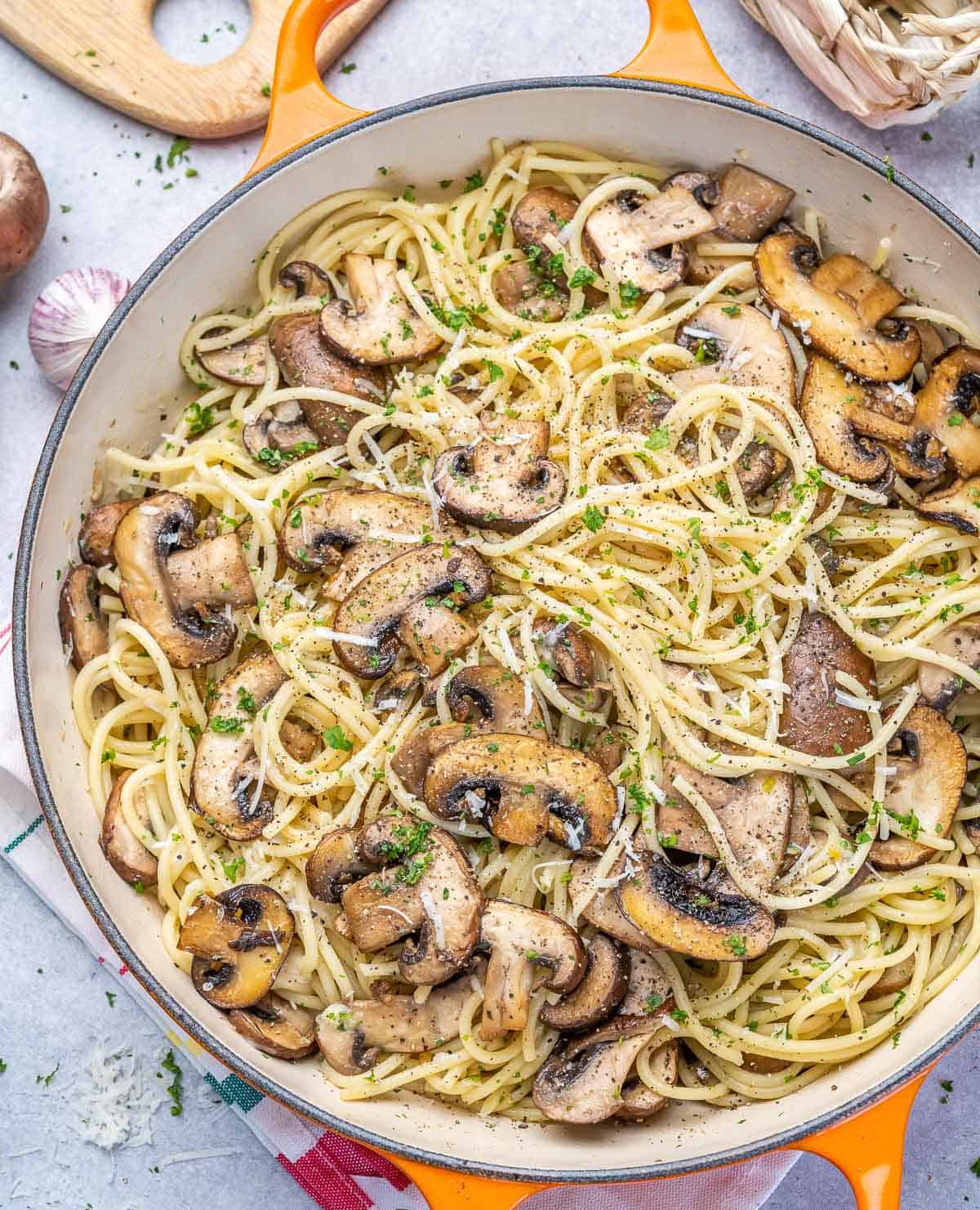 top view mushroom and spaghetti in orange skillet