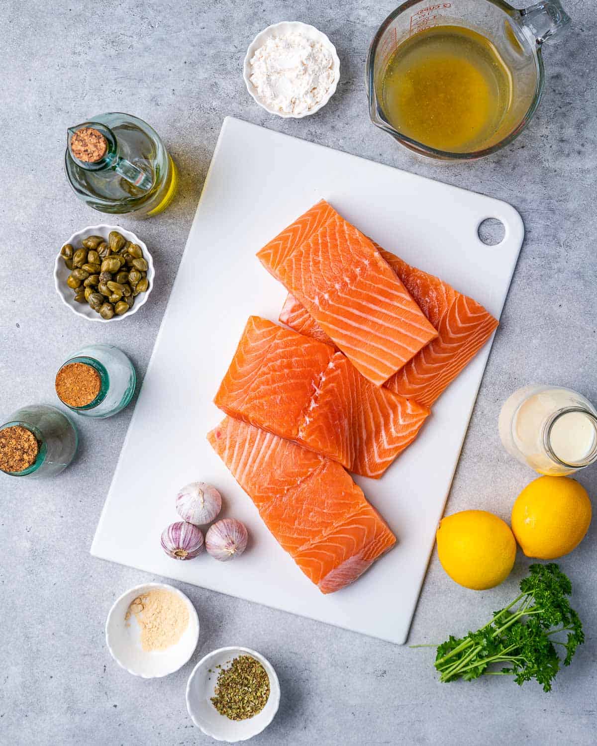 Ingredients for pan-seared salmon and lemon sauce on counter.