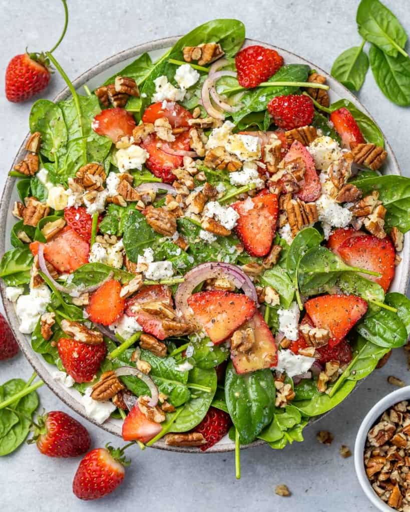 top view strawberry and spinach salad with pecans and feta