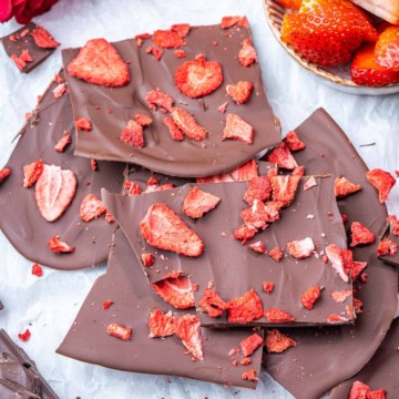 top view chocolate bark pieces topped with dried strawberries