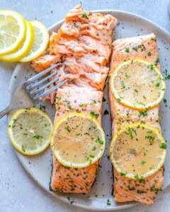 Flaked baked salmon on a plate.